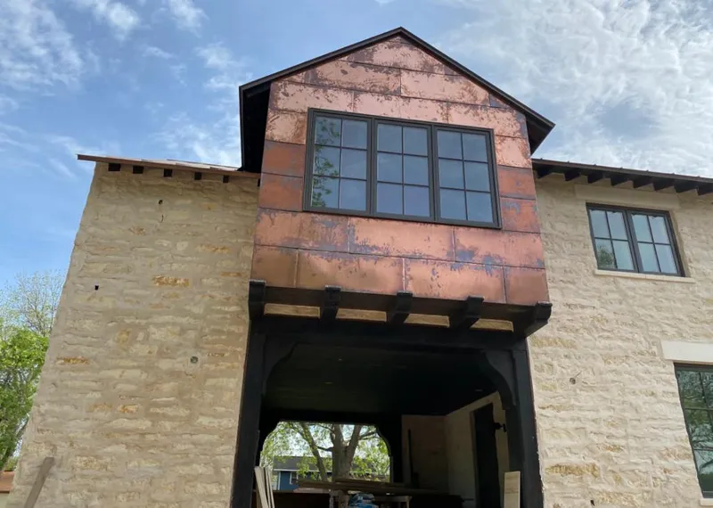 Copper metal panel facade on a stone building for Skylight Installation in Eldersburg