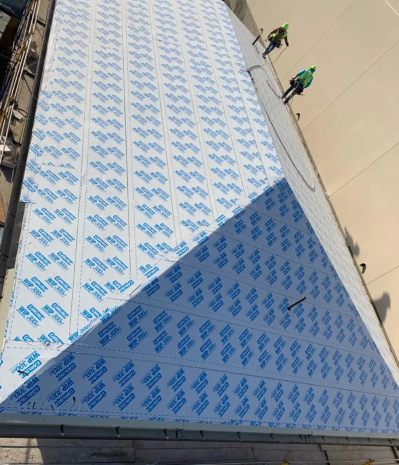 Professional roofers installing underlayment on a metal roof in Eldersburg